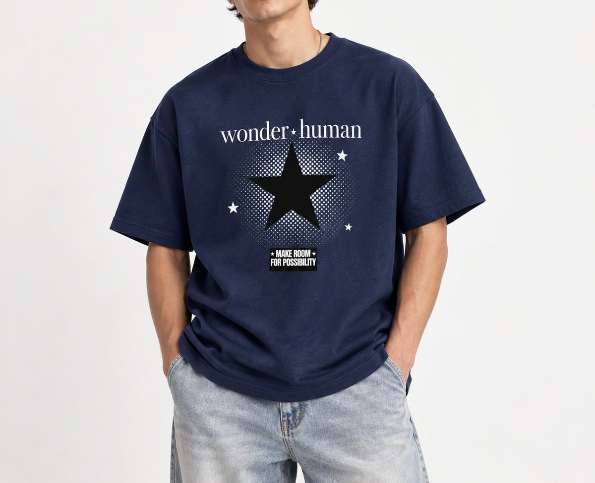 Male model wearing navy Halftone Heavyweight Tee with Wonder Human halftone star graphic