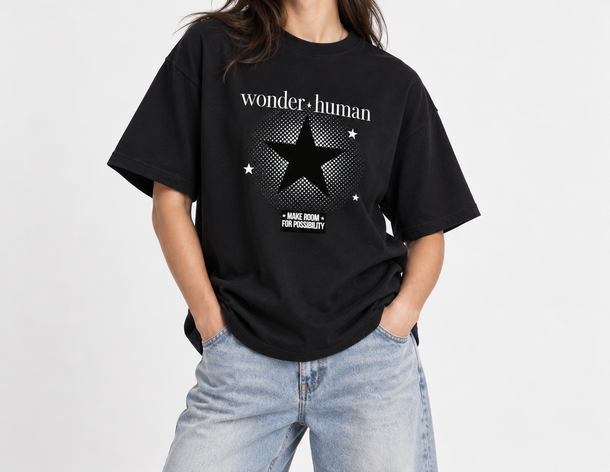 Female model wearing black Halftone Heavyweight Tee with Wonder Human halftone star graphic