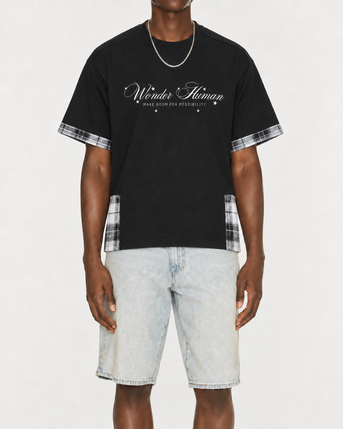 Model wearing black Plaid Panel Tee with plaid trim and Wonder Human front graphic