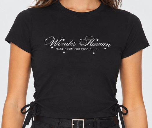 Close-up of black Ribbon Tee showing Wonder Human front graphic and adjustable side ties