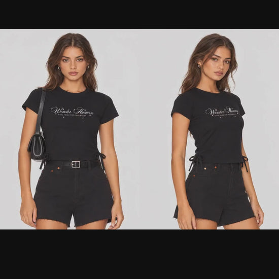 Video of model wearing black Ribbon Tee, front and angled views showing fitted cropped silhouette and side ties